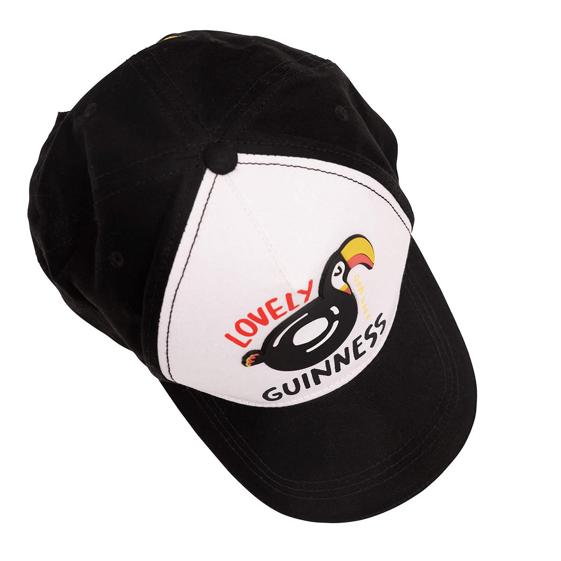 A FATTI BURKE "LOVELY DAY FOR A GUINNESS" TOUCAN BASEBALL CAP, designed by Fatti Burke, featuring a black and white summer-style baseball cap with a toucan on it.