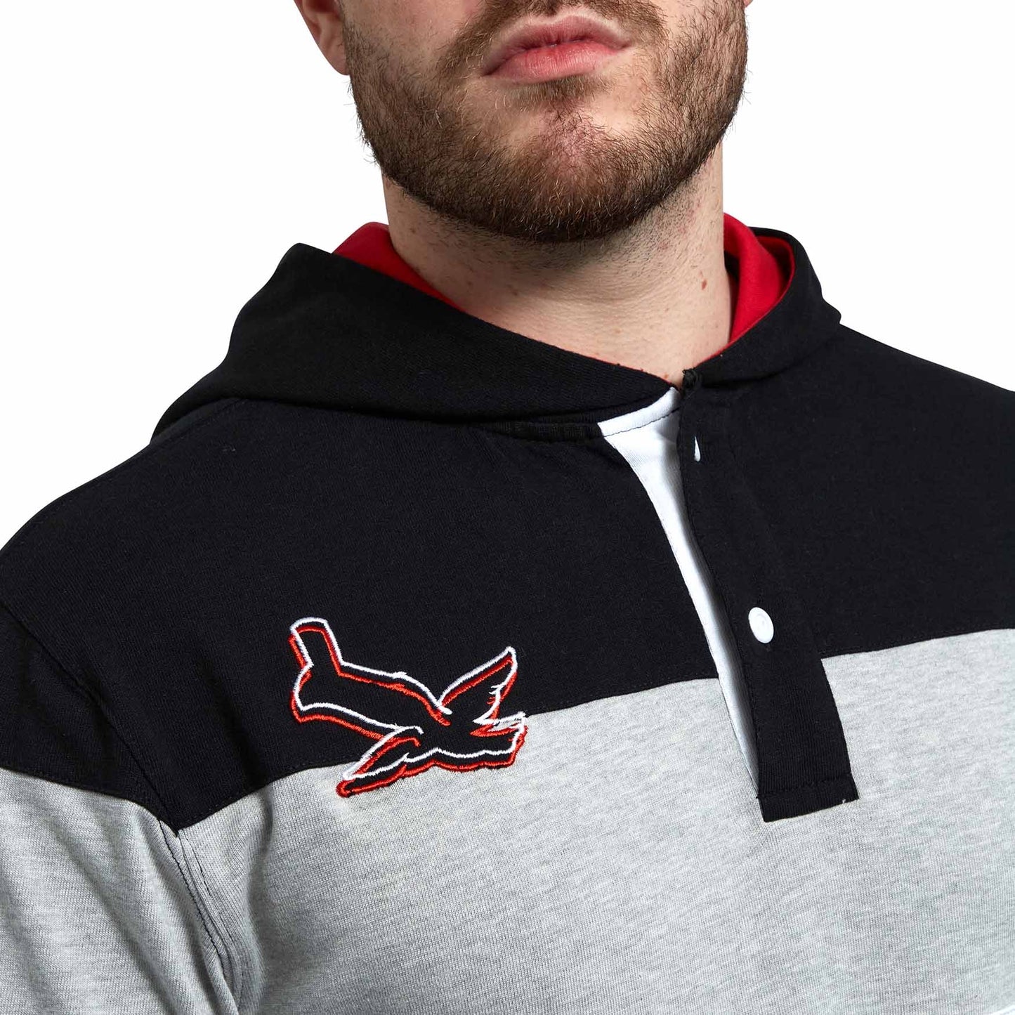 A hooded man, wearing a Guinness Black & Red Toucan Hooded Rugby hoodie.