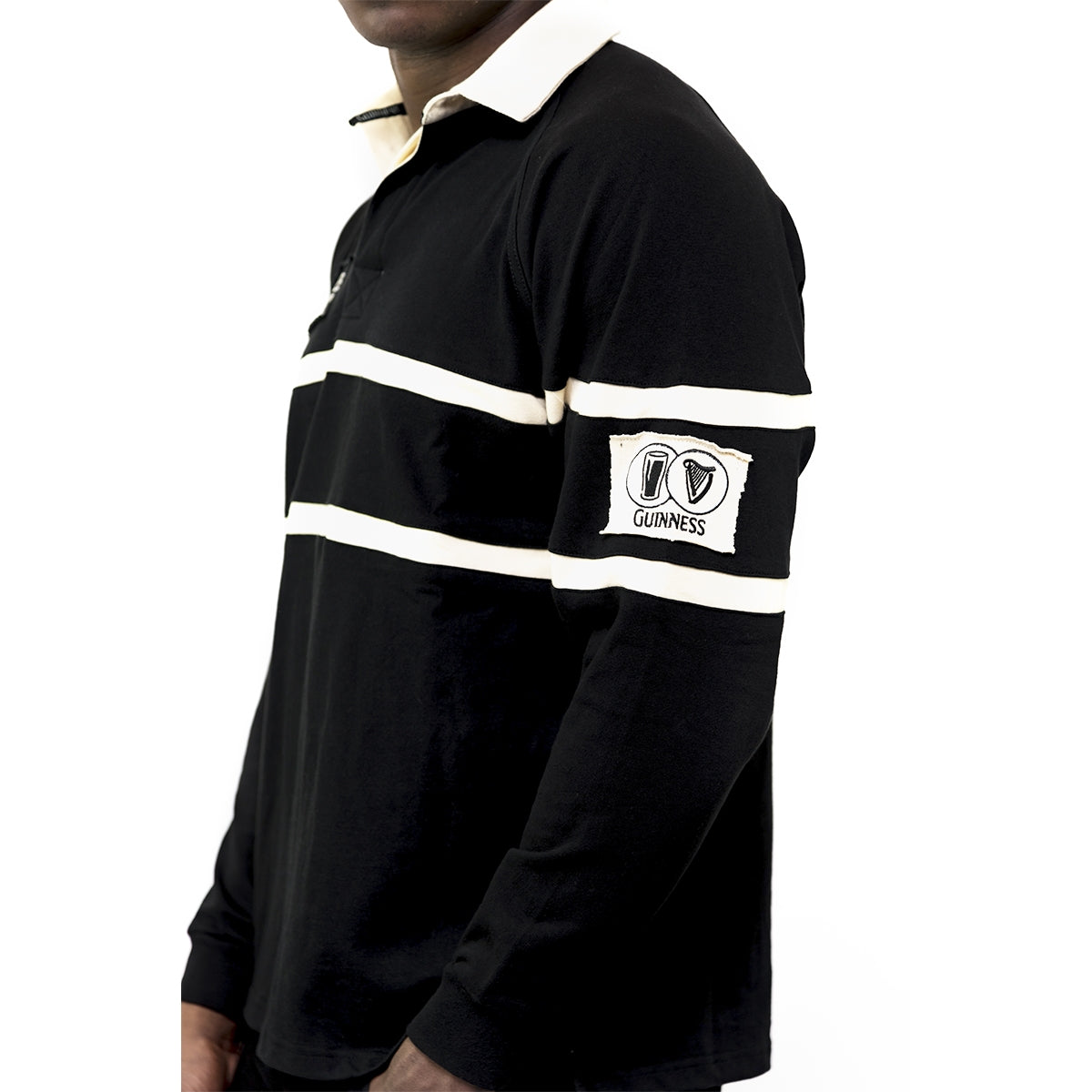 A man sporting an authentic Guinness Traditional Rugby Jersey in a black and white cotton jersey fabric shirt.