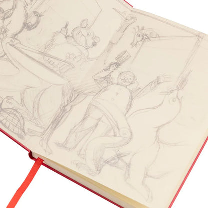 Open Guinness Gilroy notebook featuring rough pencil drawings of whimsical characters and objects, including the Gilroy Toucan, with a visible red bookmark.