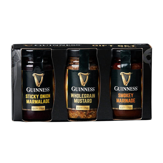 A delectable Guinness Foodstuff Gift Set featuring three Guinness sauces, including Guinness Sticky Onion Marmalade and Guinness Wholegrain Mustard, elegantly presented in a sleek black box.