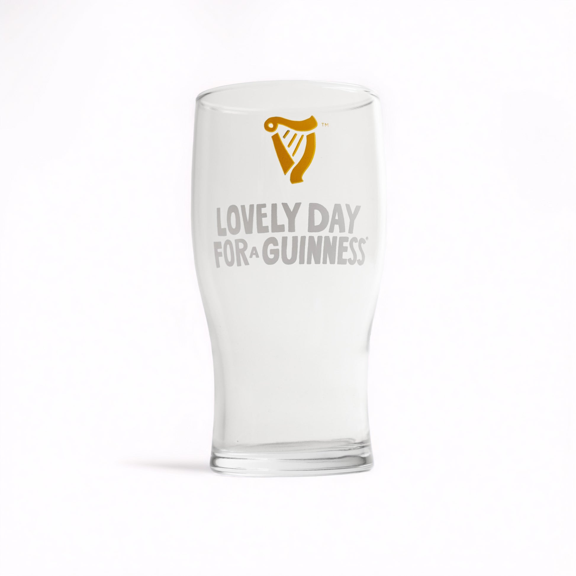 The Guinness Seb Curi Lovely Day Pint Glass from Guinness Webstore US features the harp logo and "Lovely Day for a Guinness" text—perfect for fans and collectors of the iconic brand.