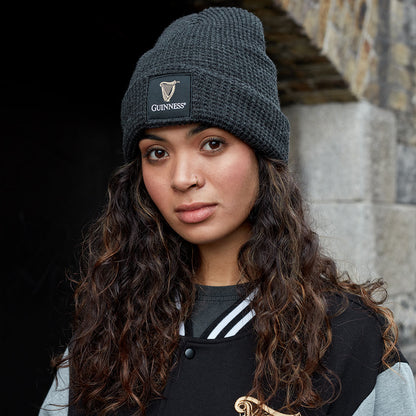 A young woman wearing a Guinness Thinsulated Beanie.