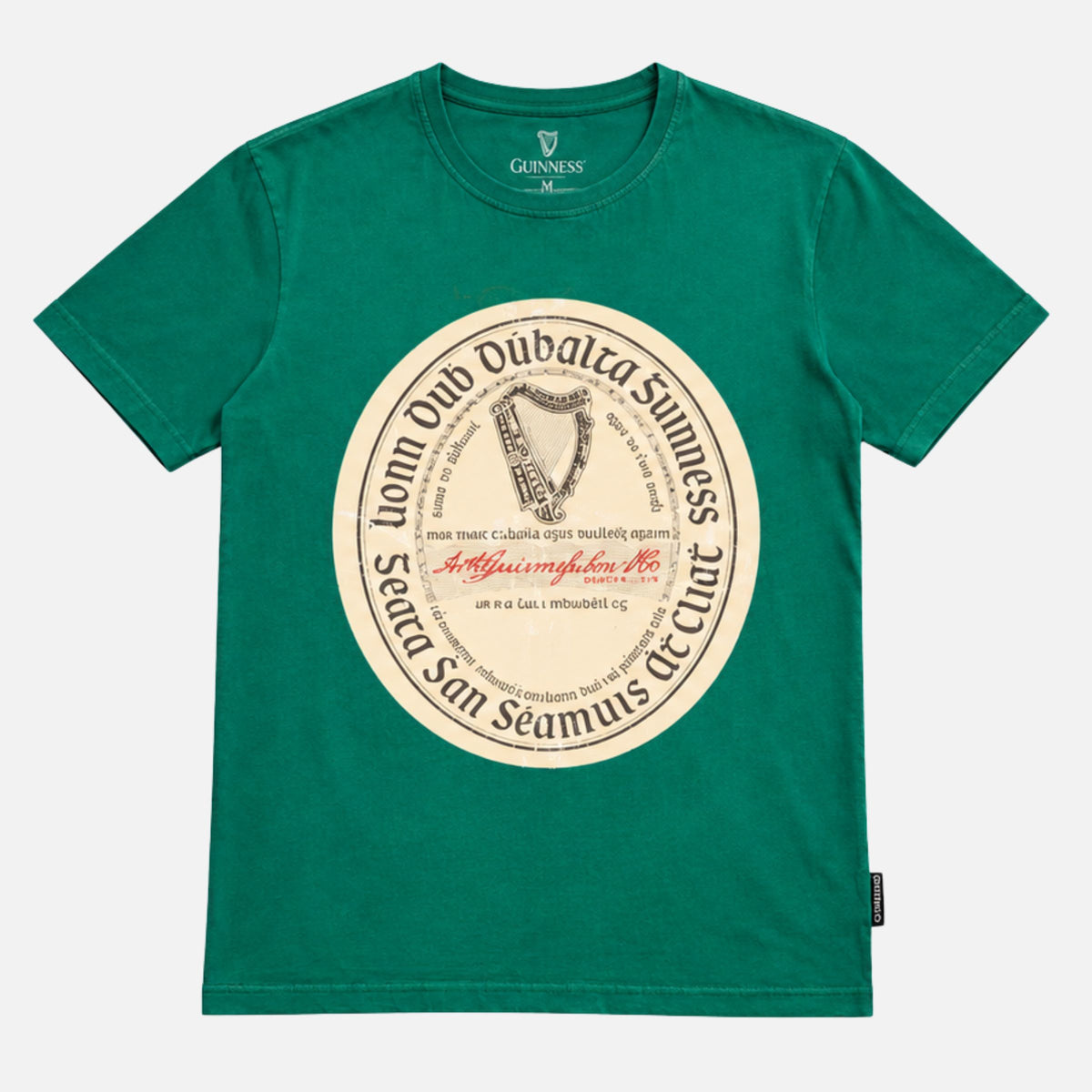 Guinness Green Label Premium Tee in green with short sleeves, a crew neck, and a vintage-style circular harp graphic with Gaelic text on the chest.