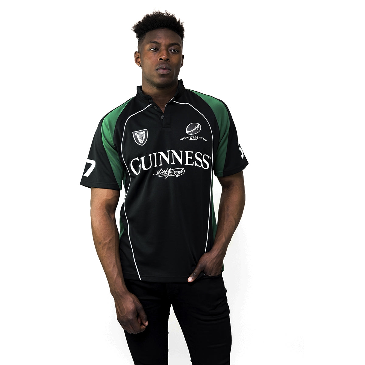 A man wearing a black and green Guinness Short Sleeve Performance Rugby Jersey.