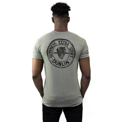 The back view of a man wearing a Guinness Green Heathered Bottle Cap Tee.