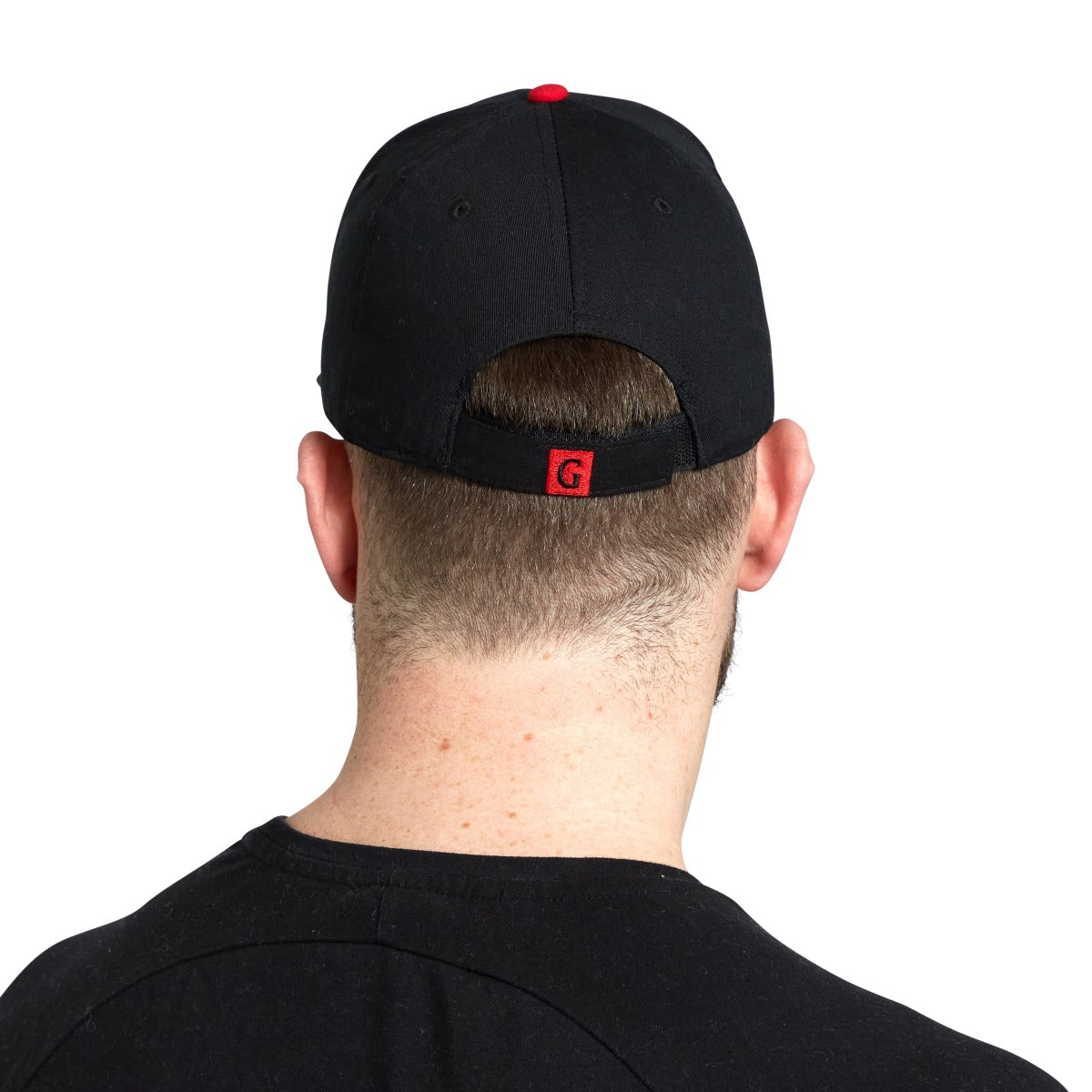 The back view of a man wearing a Guinness Toucan Baseball Cap.