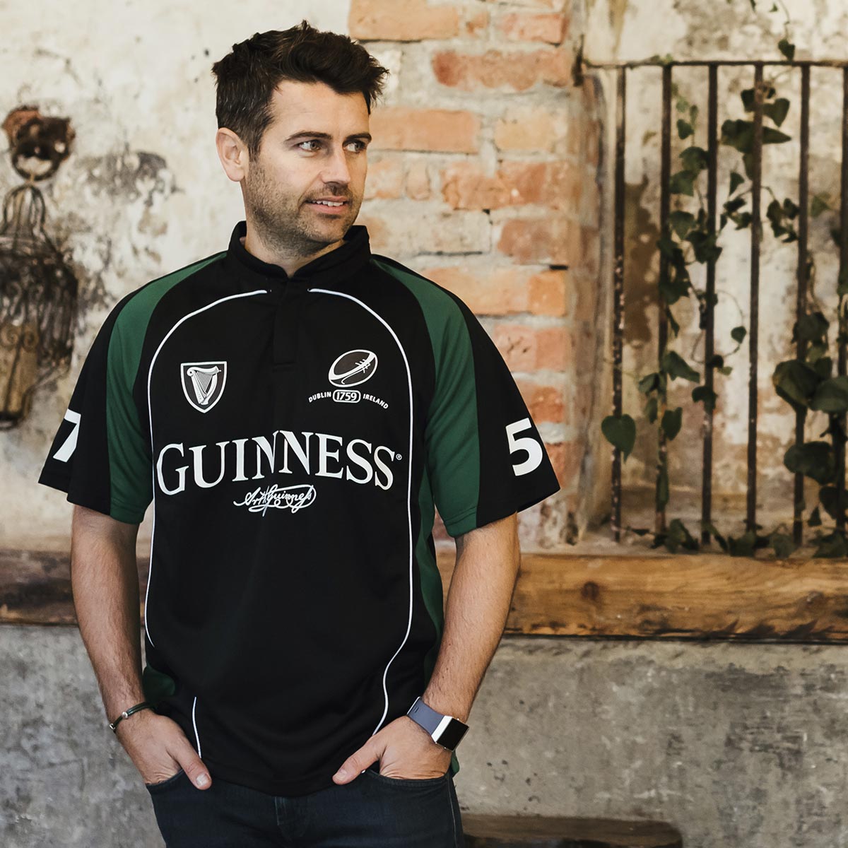A man sporting a Guinness Short Sleeve Performance Rugby Jersey.