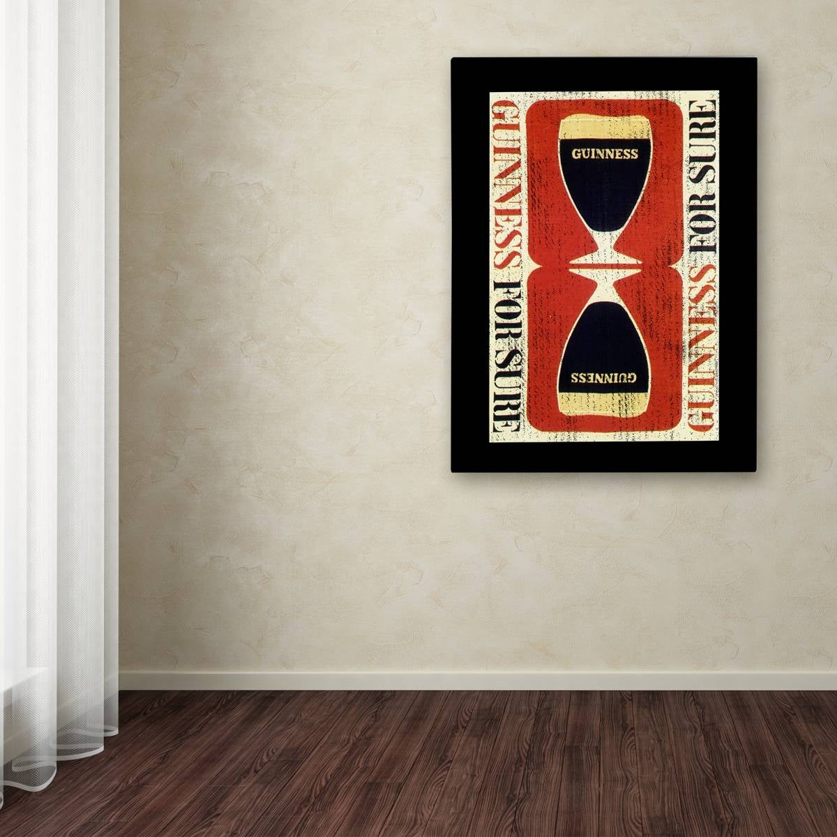 A Guinness Brewery 'Guinness For Sure' canvas art showcasing a minimalist aesthetic of a beer glass, beautifully framed and hung on the wall.