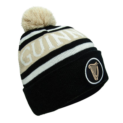 A warm and cozy black Guinness Black and White Premium Beanie hat with a pom pom.