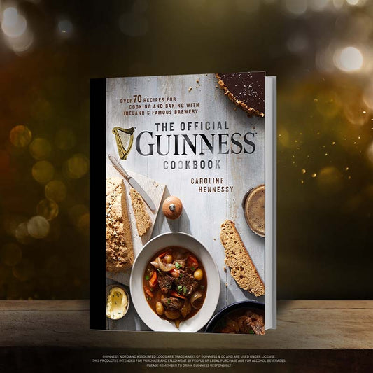 The Official Guinness Hardcover Cookbook filled with delicious recipes sits proudly on a table.