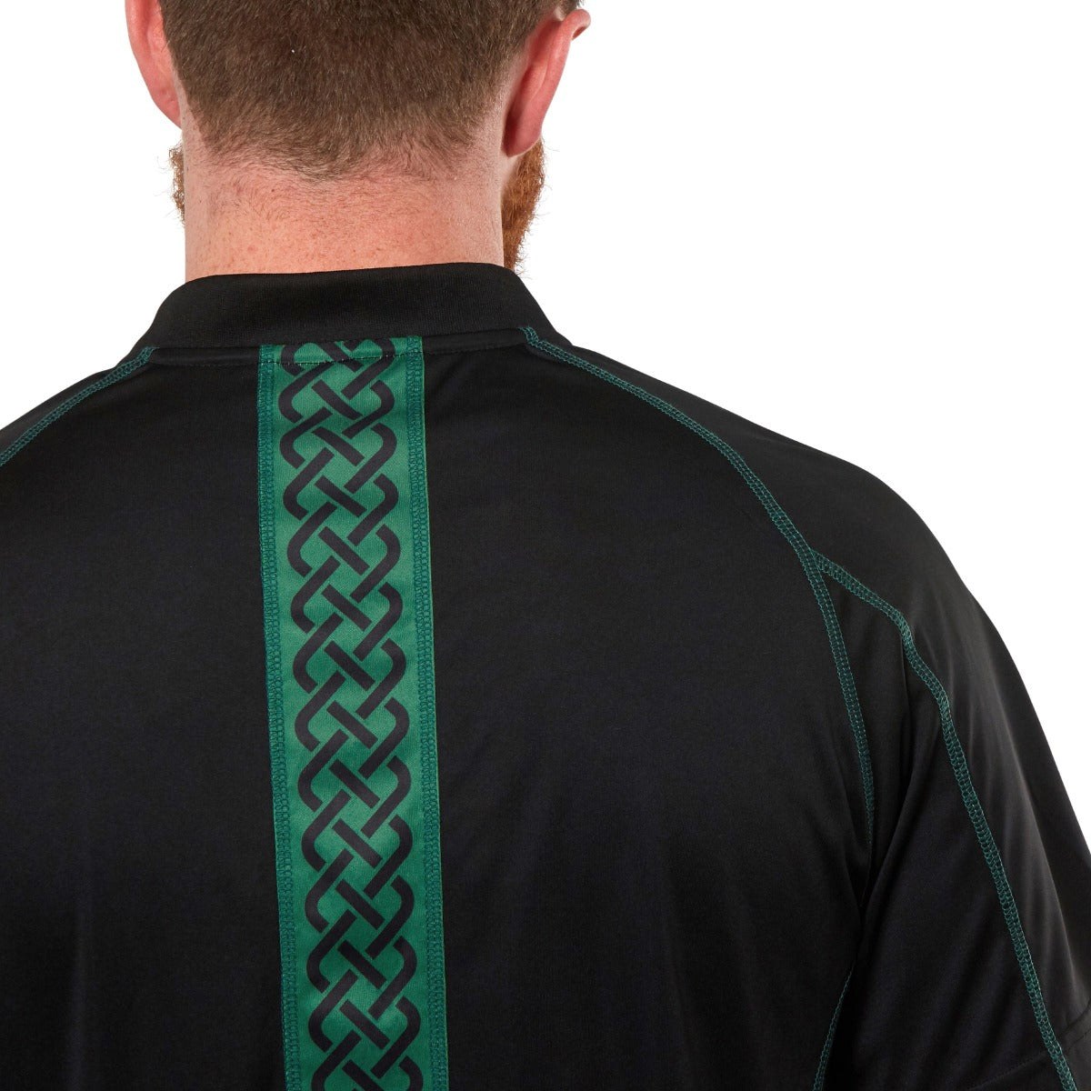 The back of a man wearing a Guinness Black & Green Short Sleeve Rugby Jersey.