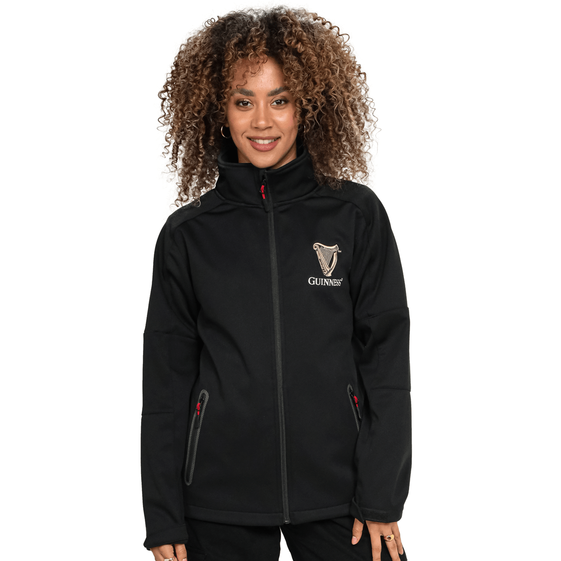 A person wearing a black, Guinness Soft Shell Waterproof Jacket with zipped pockets and a high collar, standing against a plain white background.