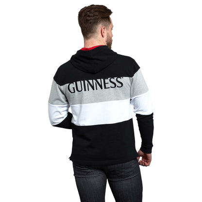 A man wearing a Guinness Black & Red Toucan Hooded Rugby.