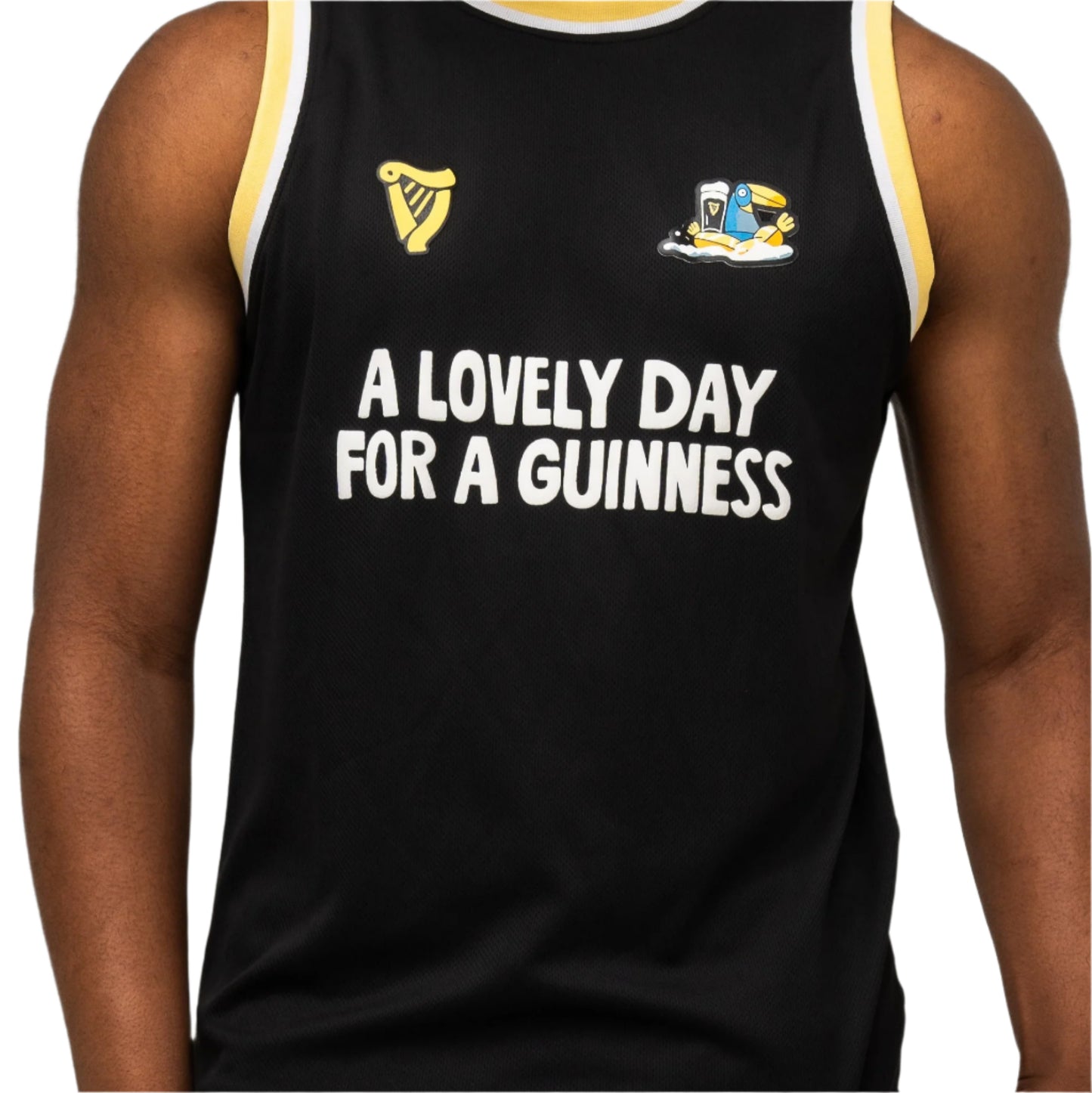A person wearing the Guinness Seb Curi Basketball Jersey—a black sleeveless shirt from Guinness Webstore US featuring "A LOVELY DAY FOR A GUINNESS" and limited-edition Sebastian Curi graphics.