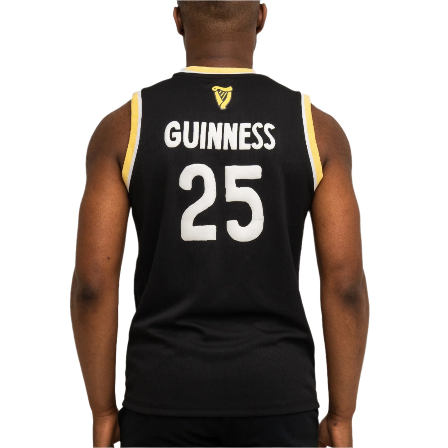 A person is seen from behind wearing the Guinness Webstore US limited-edition Seb Curi Basketball Jersey, a black sleeveless top featuring “GUINNESS” and the number 25 in white on the back.