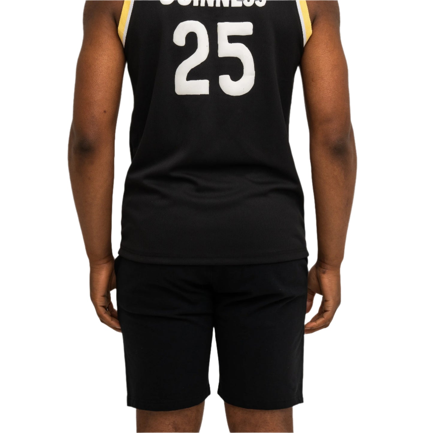 A person facing away from the camera wears a black sleeveless jersey with "GUINNESS" and the number 25 on the back, paired with Guinness Seb Curi Beach Short - Black from Guinness Webstore US.