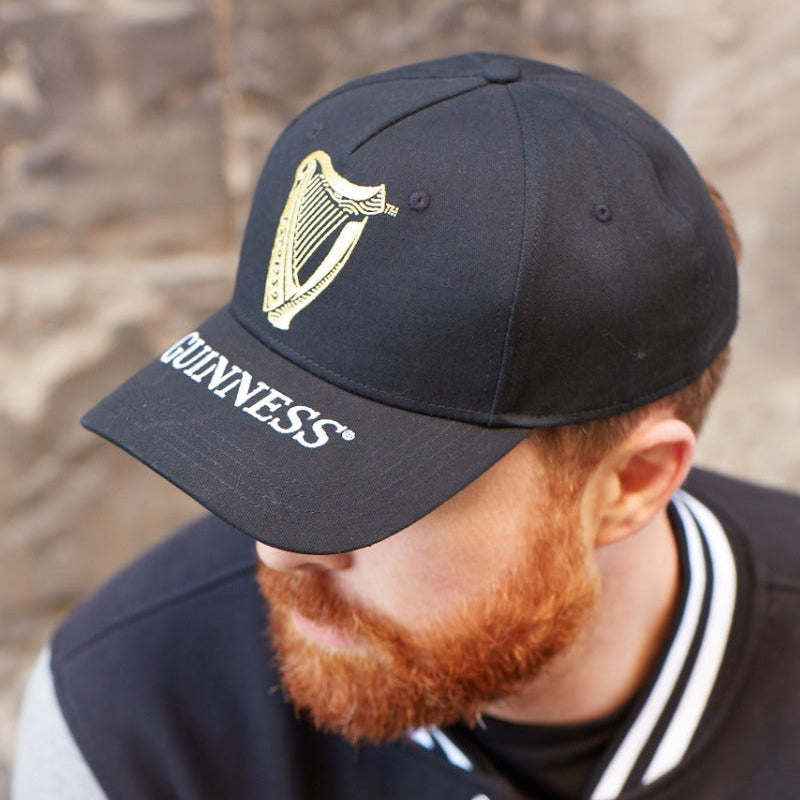A man with a beard wearing a Guinness Harp Baseball Cap.