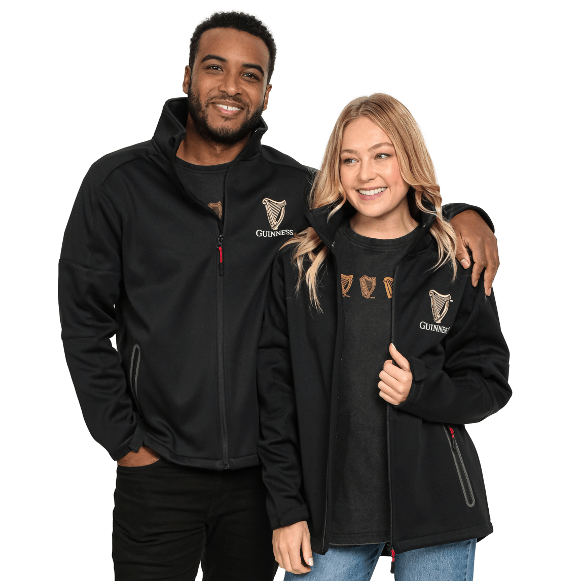 Two people, one man and one woman, are smiling while wearing matching Guinness Soft Shell Waterproof Jackets. The man has his arm around the woman's shoulder.