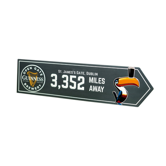 A Guinness Open Gate Brewery Arrow Metal Sign featuring a toucan.