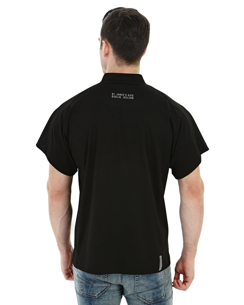 The back view of a man sporting an All Black Rugby Jersey with a touch of Guinness branding.