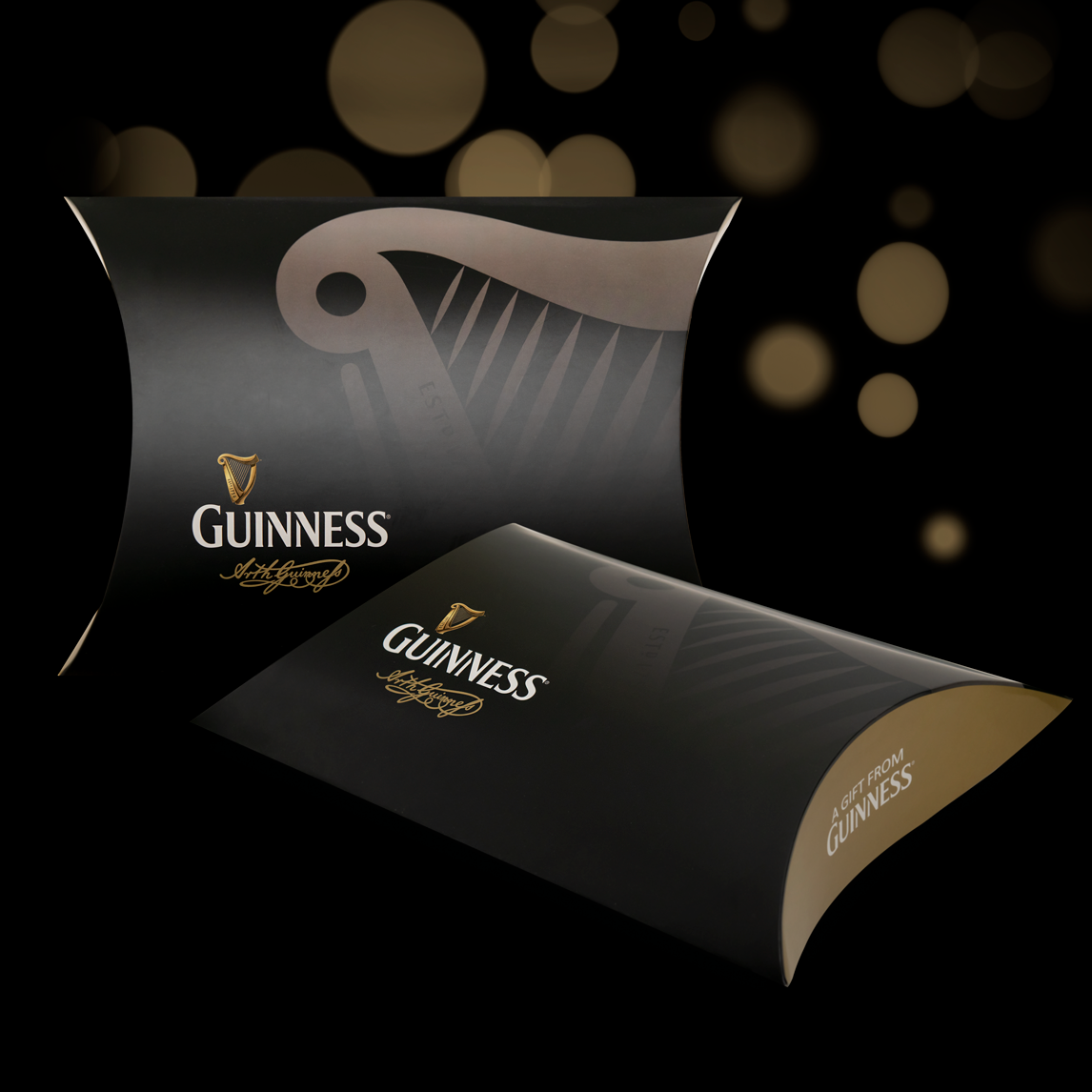 Two black, curved Guinness Clothing Gift Boxes featuring a harp logo and text branding.