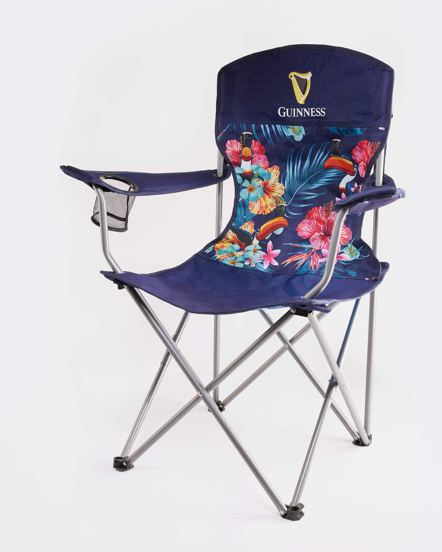 The Guinness Toucan Hawaiian Beach Chair from Guinness Webstore US features sturdy metal legs, a cup holder, and vibrant tropical seat and backrest prints with the iconic Guinness logo and toucan—making it a stylish beach essential.