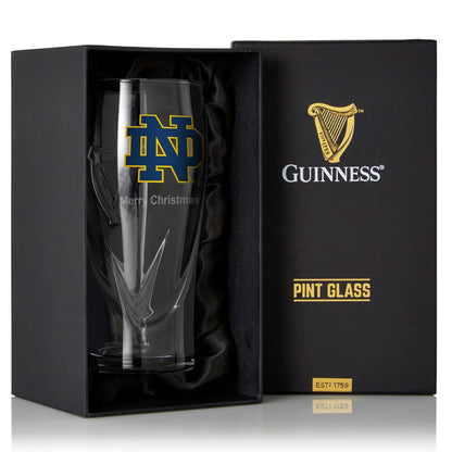 A Guinness Notre Dame 16OZ Pint Glass in a box.