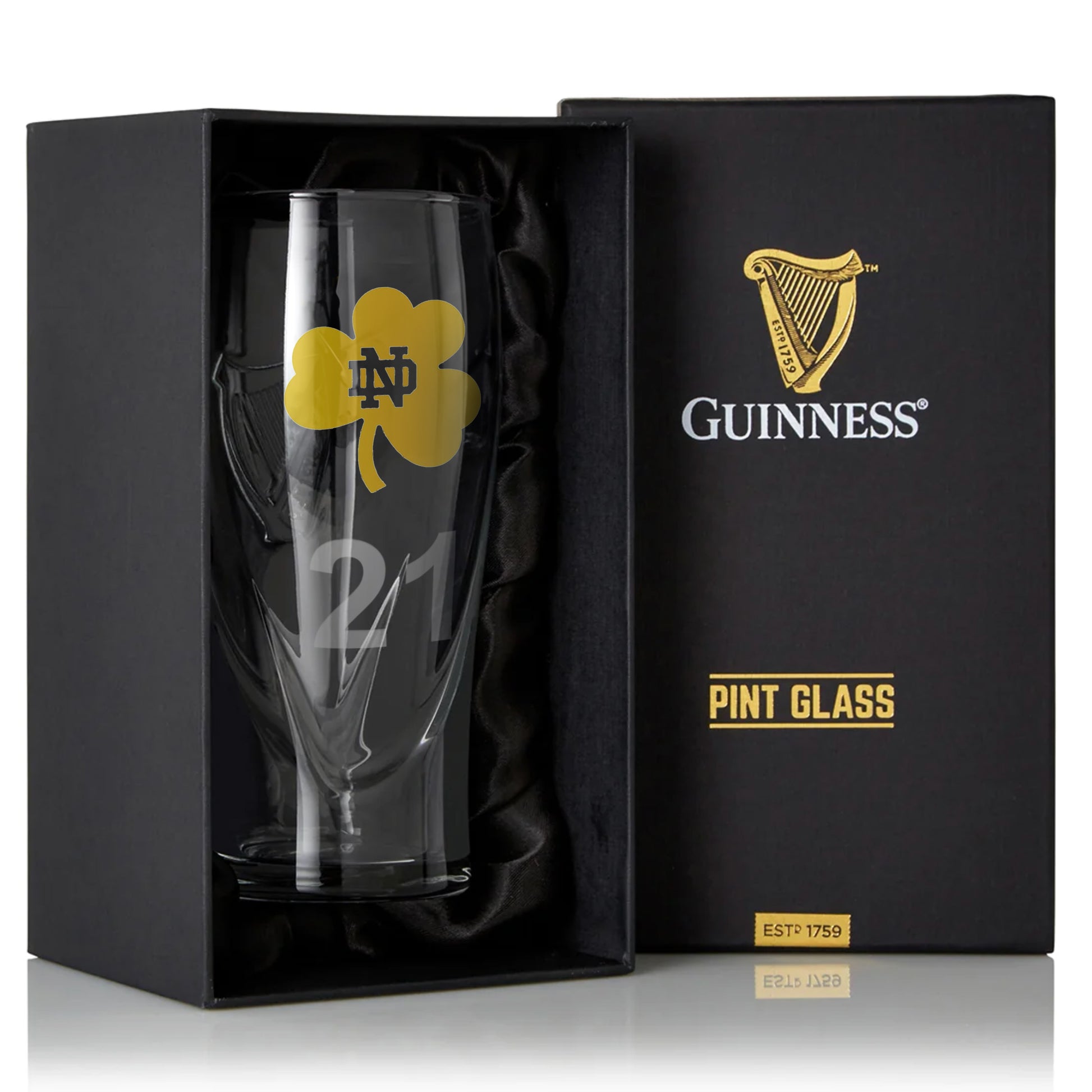 A Notre Dame Guinness Shamrock 16oz Pint Glass in a box with a shamrock on it.