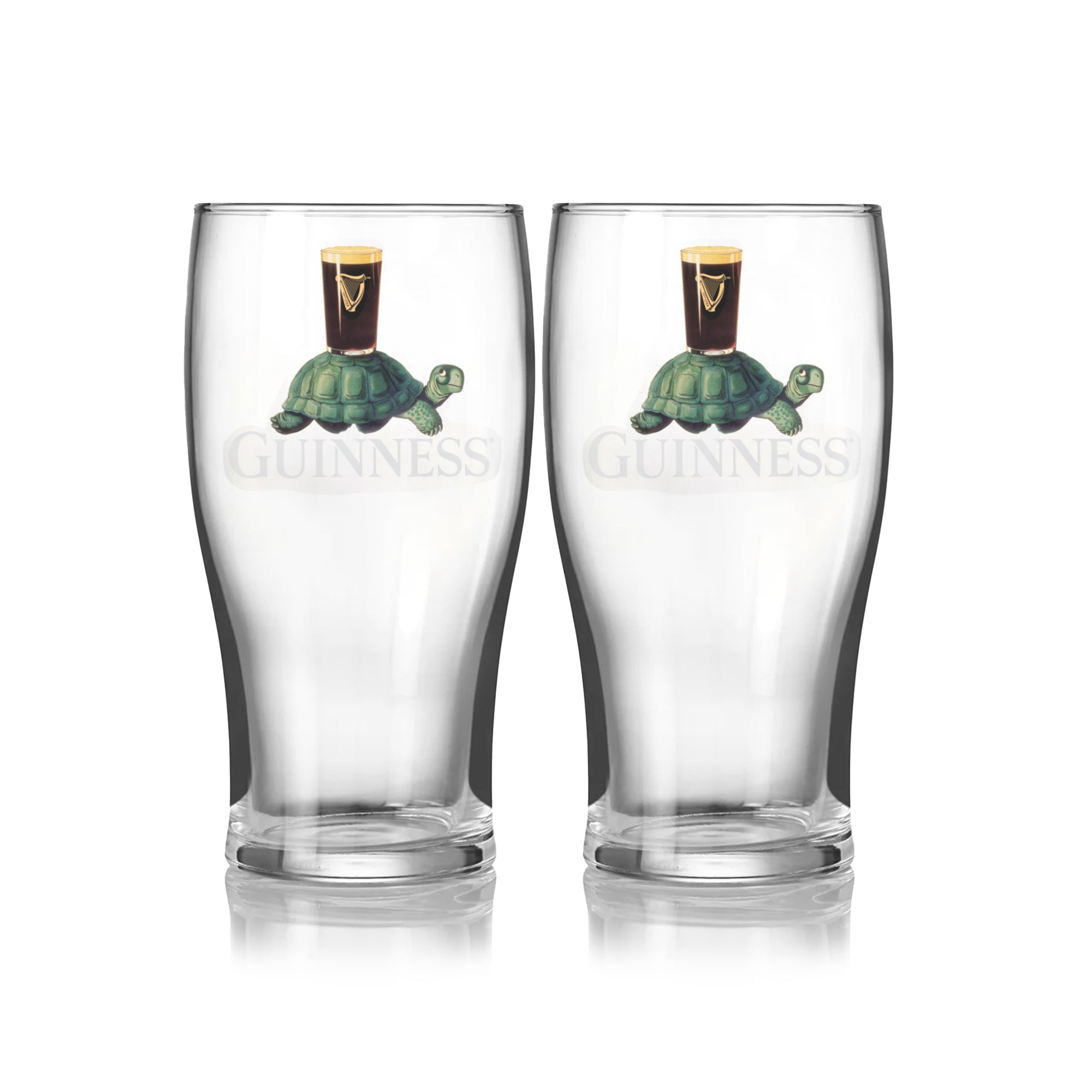 The Guinness Gilroy Tortoise Pint Glass - 2 Pack from Guinness Webstore US features two clear glasses with the iconic Gilroy tortoise carrying a pint and the classic Guinness logo on the front.