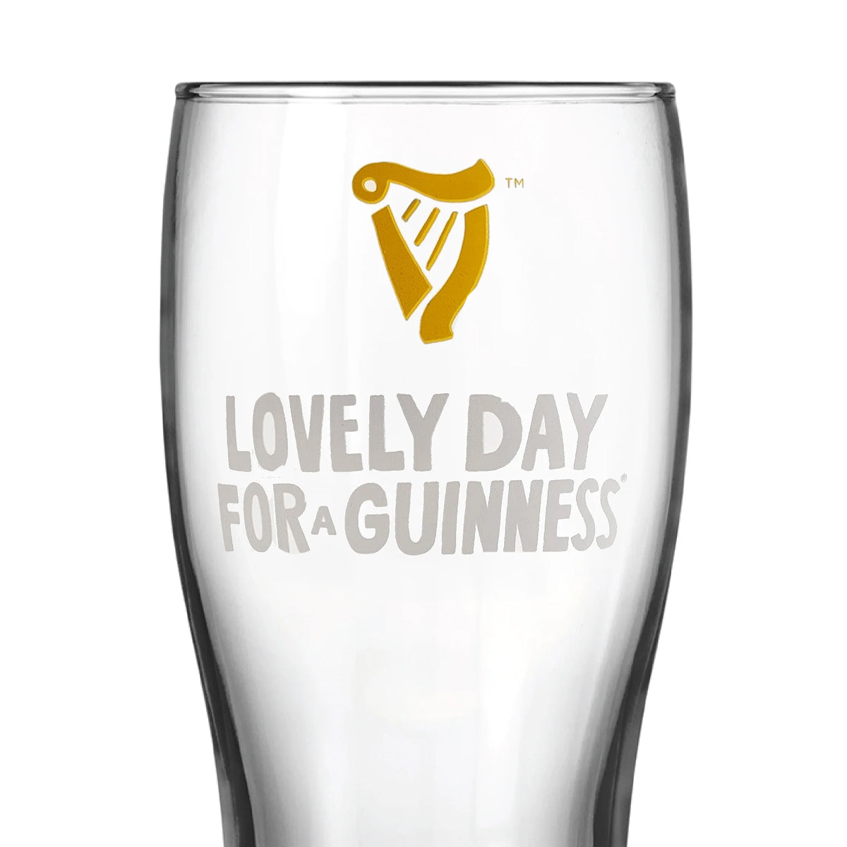 Guinness Summer Collection Lovely Day Pint Glass made of clear glass with a gold harp icon above the text “LOVELY DAY FOR A GUINNESS.”