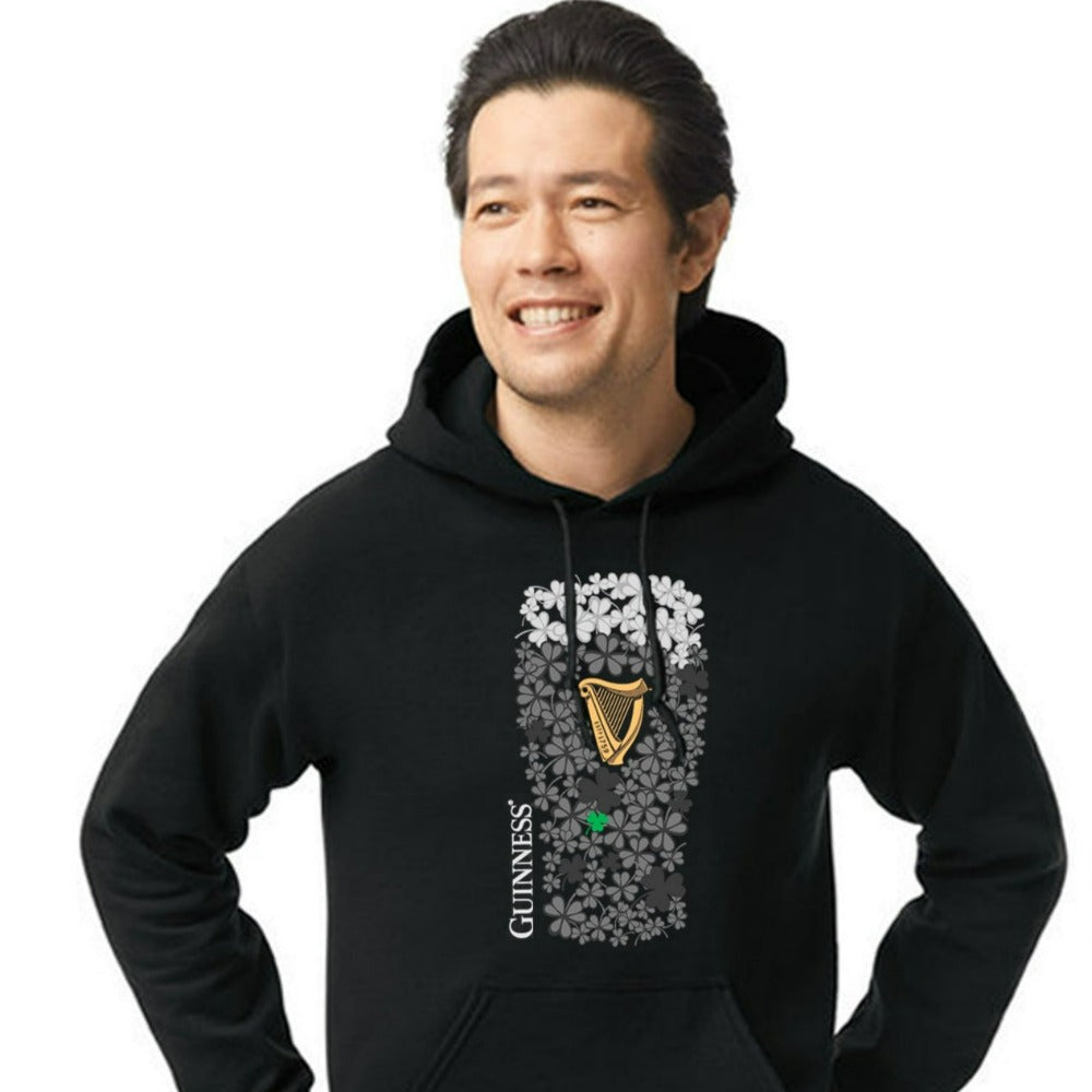 A man wearing a St. Patrick's Day Shamrock Pint Black Hoodie featuring a Guinness mug.