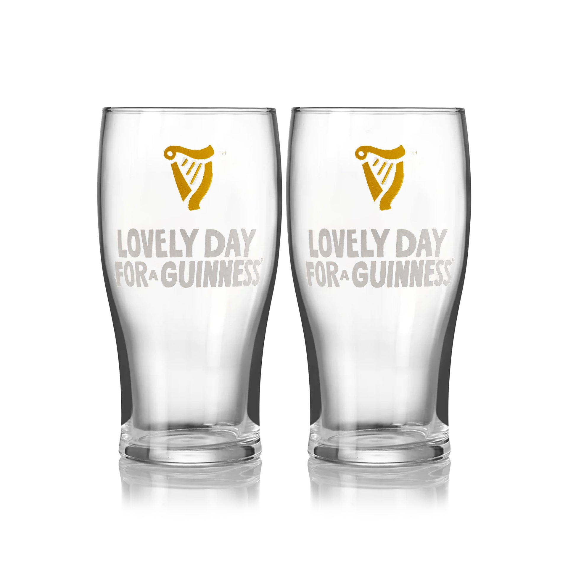 The Guinness Seb Curi Lovely Day Pint Glass 2 Pack from Guinness Webstore US features two collector’s edition pint glasses with the harp logo and "Lovely Day for a Guinness," inspired by Sebastian Curi, shown side by side on a white background.