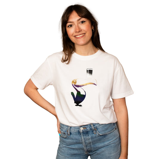 Young woman in a white Guinness Liquid Toucan Tee smiling and posing against a white background.