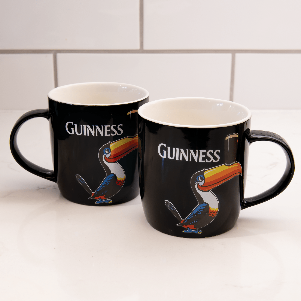 A Guinness Toucan Mug Set featuring two mugs adorned with a toucan design.