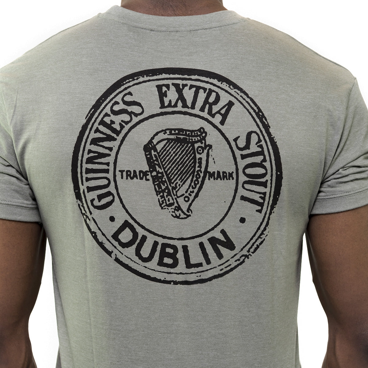 The back of a man wearing a Green Heathered Bottle Cap Tee from Guinness.
