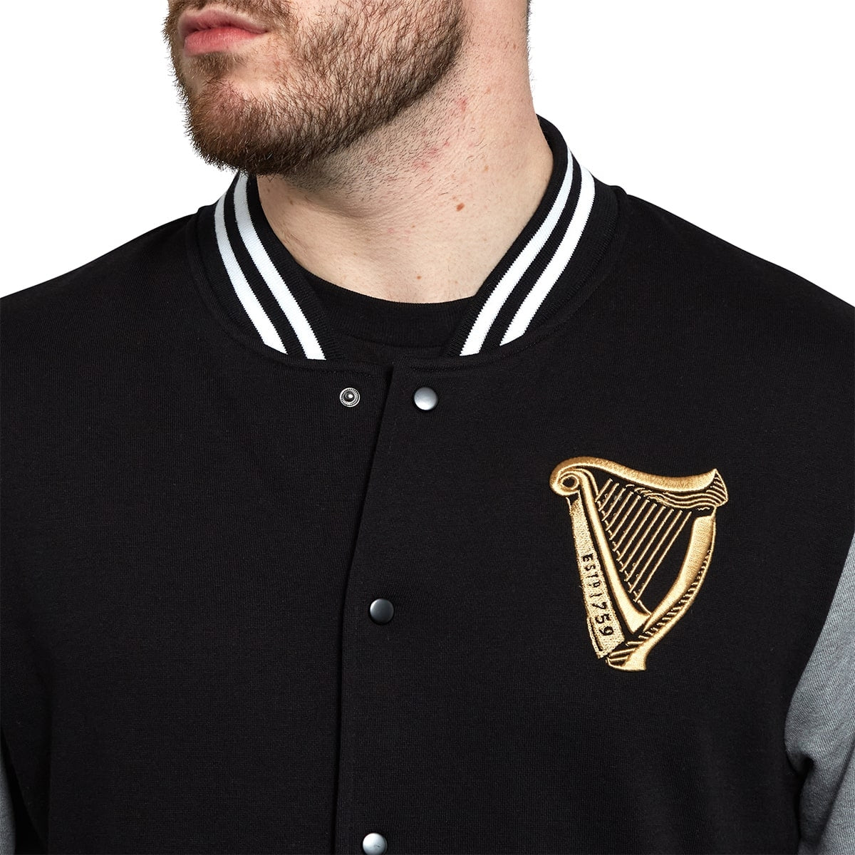 A man wearing a Guinness Letterman jacket.