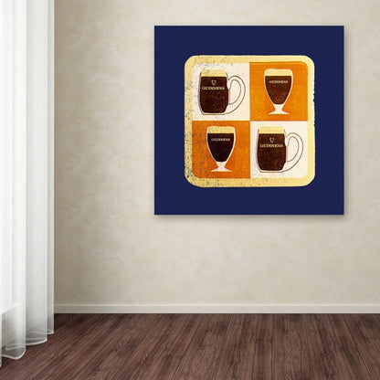Three Guinness Brewery 'Guinness II' Canvas Art mugs of beer on a wall in a room.