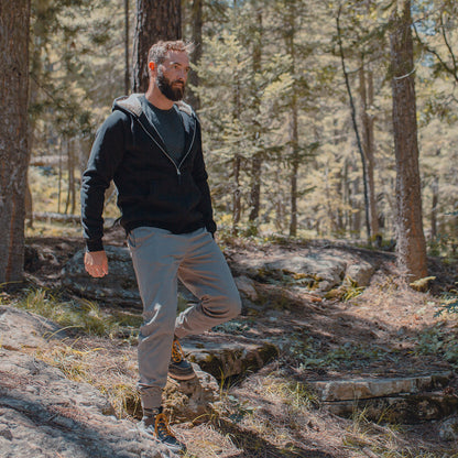 Description: A cozy, bearded man walking through the woods, snugly wrapped in a Guinness Sherpa Lined Hoodie.