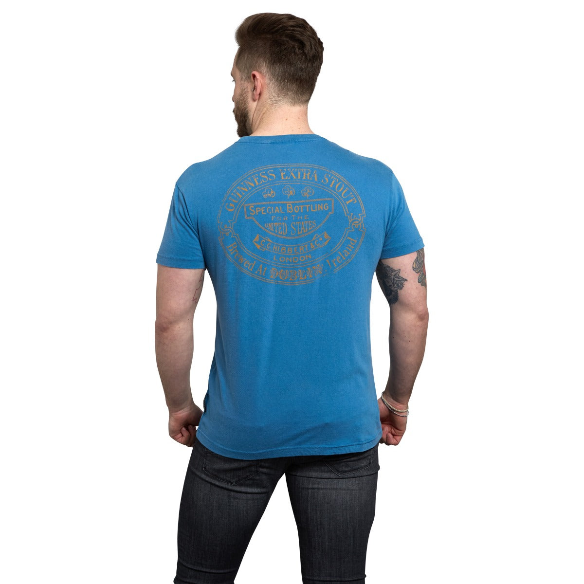 The back view of a man wearing a Guinness Trademark Label T-Shirt Blue with the Guinness brand.