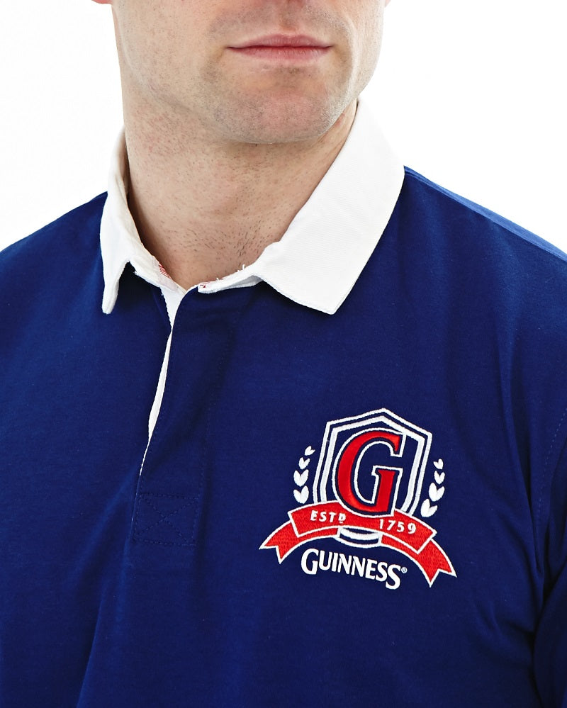 A man sporting a Guinness Classic Rugby Shirt showcasing the Guinness brand's distinct branding.