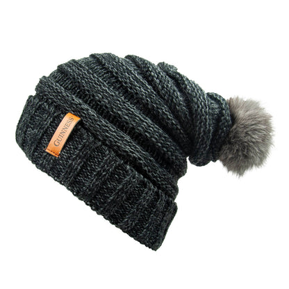 Stay warm and stylish during the winter months with this Guinness Dark Grey Slouchy Bauble Beanie with Brown Leather Patch featuring a fur pom.