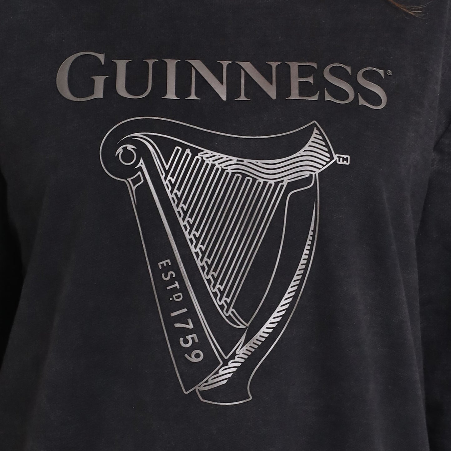 Close-up of the Guinness Embossed Print Trademark Sweater from Guinness Webstore US, crafted from soft BCI cotton fleece with an embossed logo, harp graphic, and "ESTD 1759" for vintage style.