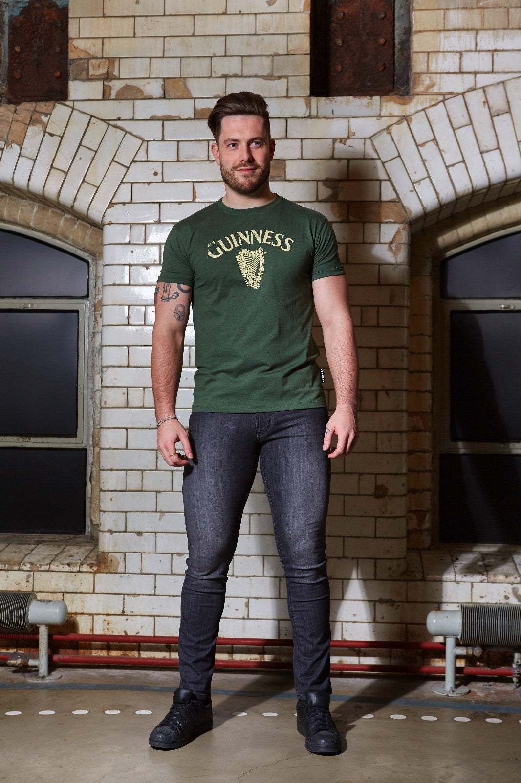 A man wearing a Guinness Vintage Harp Tee.