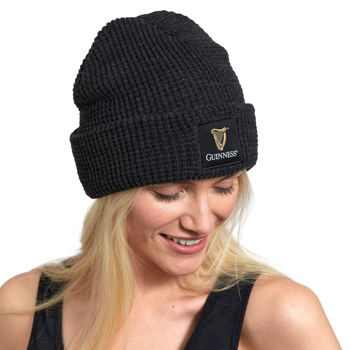 A woman wearing a Guinness Thinsulated Beanie.