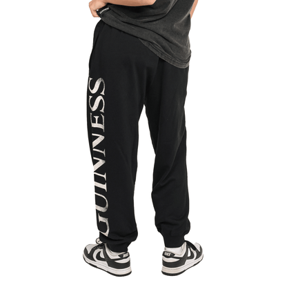 A woman wearing comfortable Guinness joggers made of organic cotton.