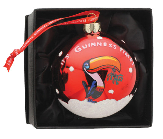A Guinness Christmas Toucan Bauble inside a box.
