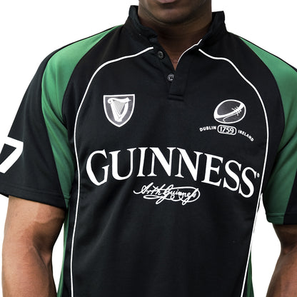A man wearing a black and green Guinness Short Sleeve Performance Rugby Jersey.