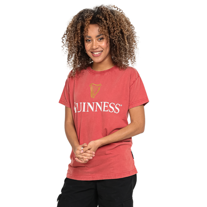 A woman wearing a premium Guinness PREMIUM HARP RED TEE in red.