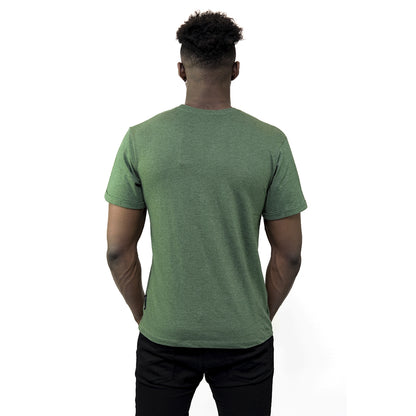 The back view of a man wearing a vintage green Guinness Vintage Harp Tee featuring the iconic Guinness harp logo.